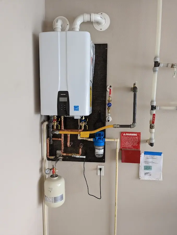 Professional plumber installing copper piping in a Woodcliff Lake home